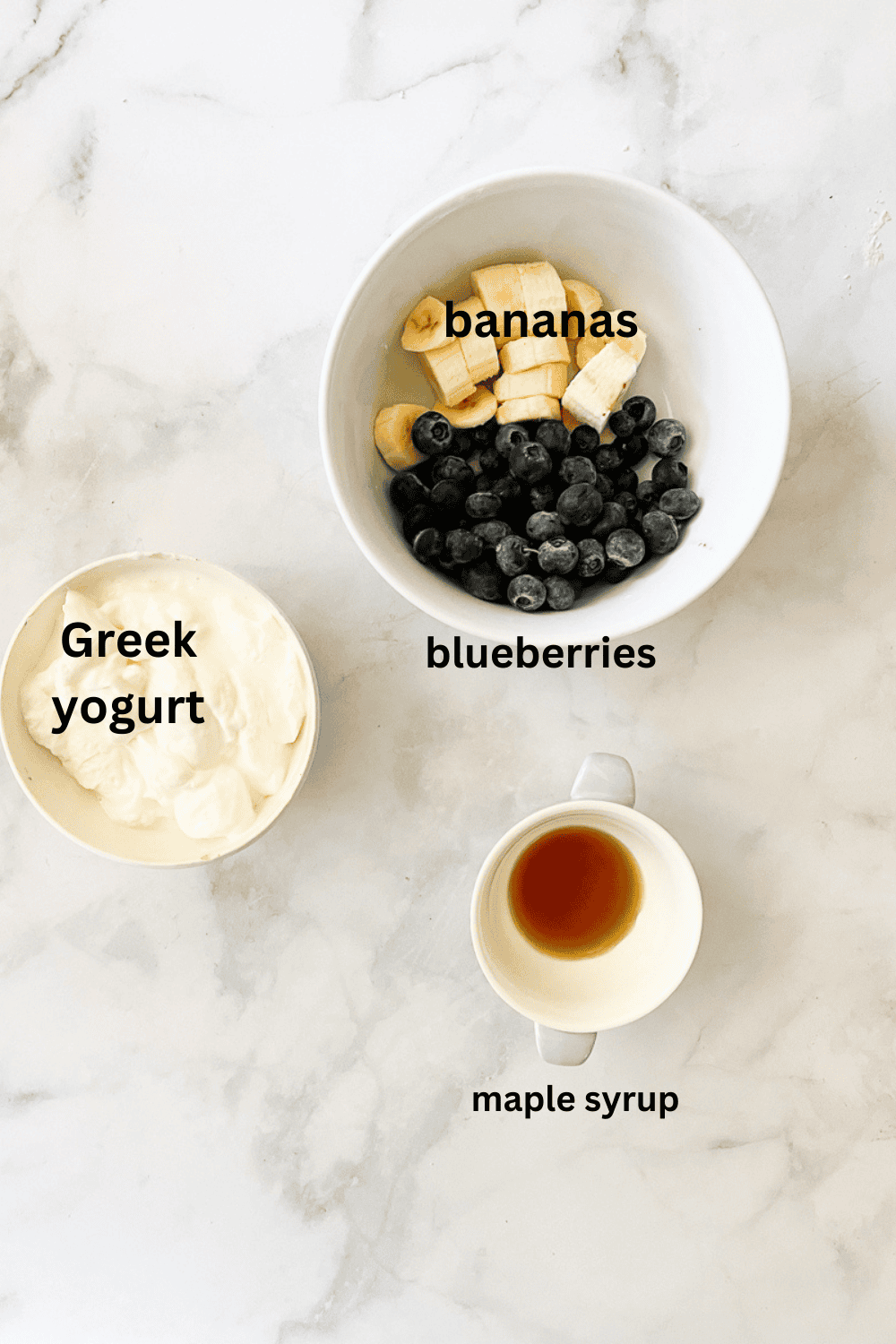 Ingredients for a blueberry banana smoothie - Greek yogurt, bananas, blueberries, maple syrup.