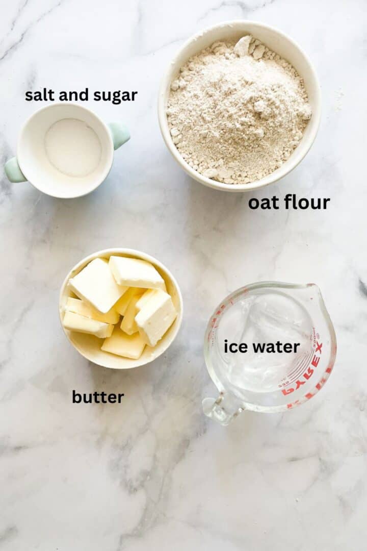 Ingredients for oat flour pie crust: oat flour, butter, ice water, salt, sugar.