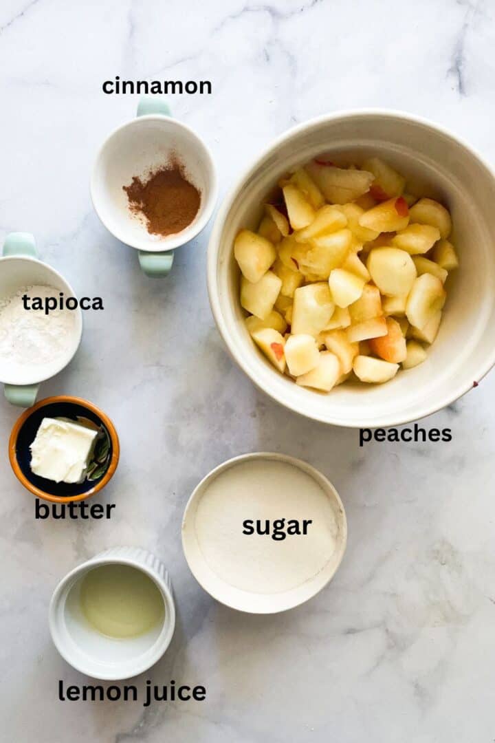 Ingredients for gluten free peach pie filling: peaches, tapioca, cinnamon, sugar, butter, lemon juice.