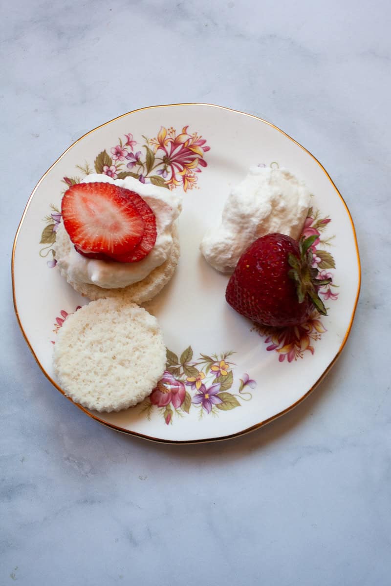 Strawberries and whipped cream on angel food cupcakes.