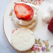 Strawberries and whipped cream on angel food cupcakes.