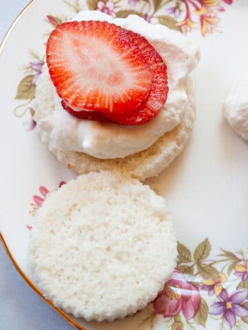 Strawberries and whipped cream on angel food cupcakes.