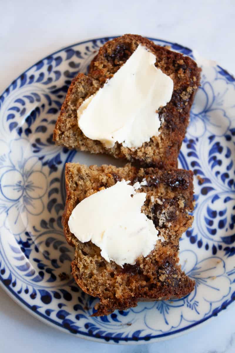 Butter tops a piece of banana bread.