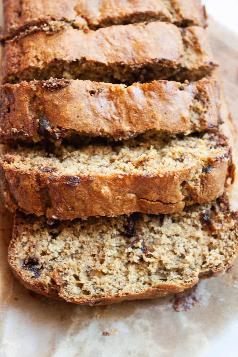 Slices of oat flour chocolate banana bread on a cutting board.