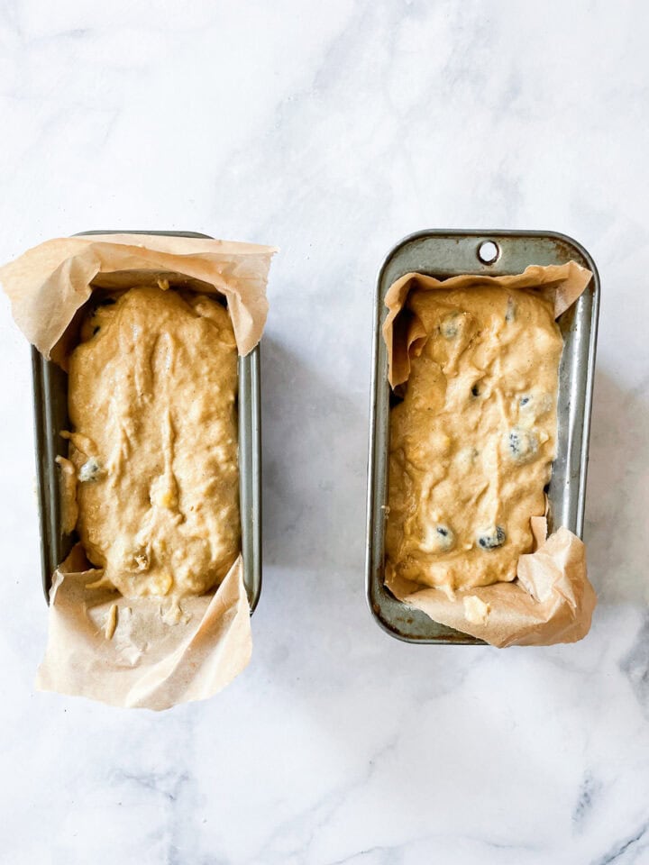 The batter is added to two lined mini loaf pans.