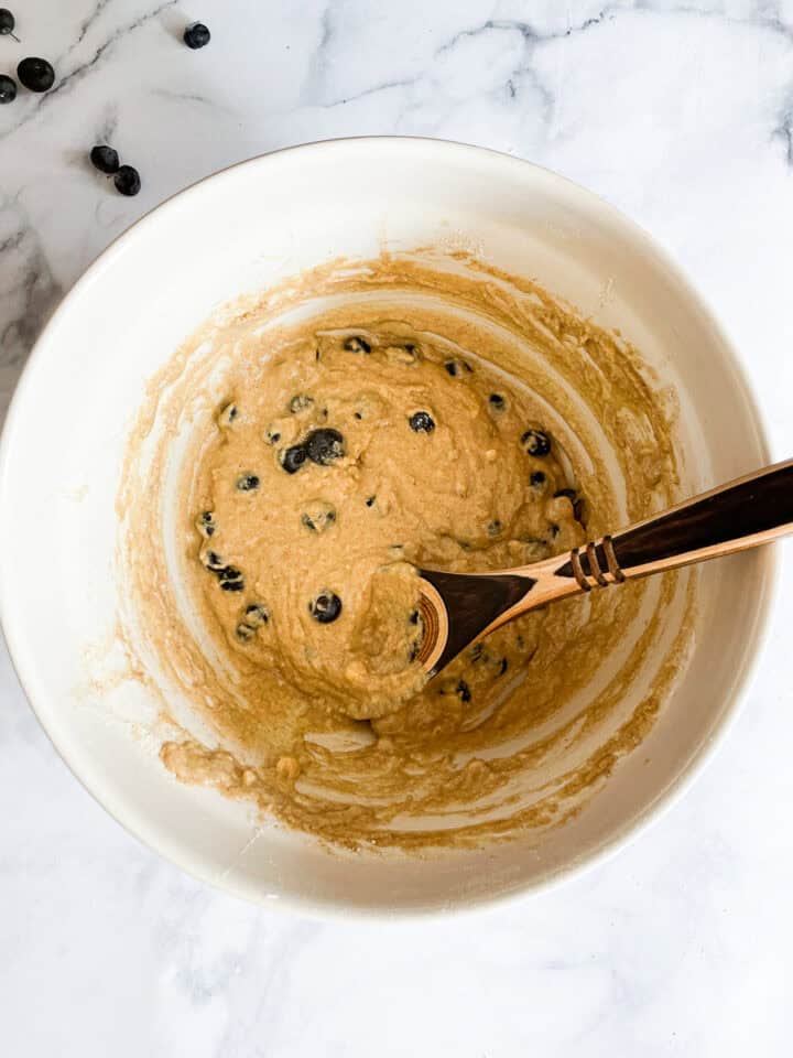 Blueberries are folded into the batter.