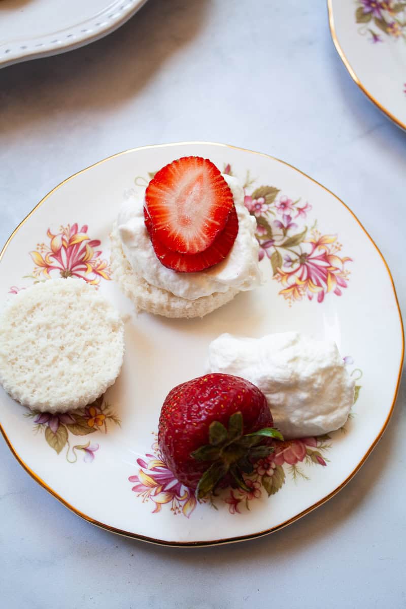 Some of the gluten free strawberry shortcakes are served on a plate.