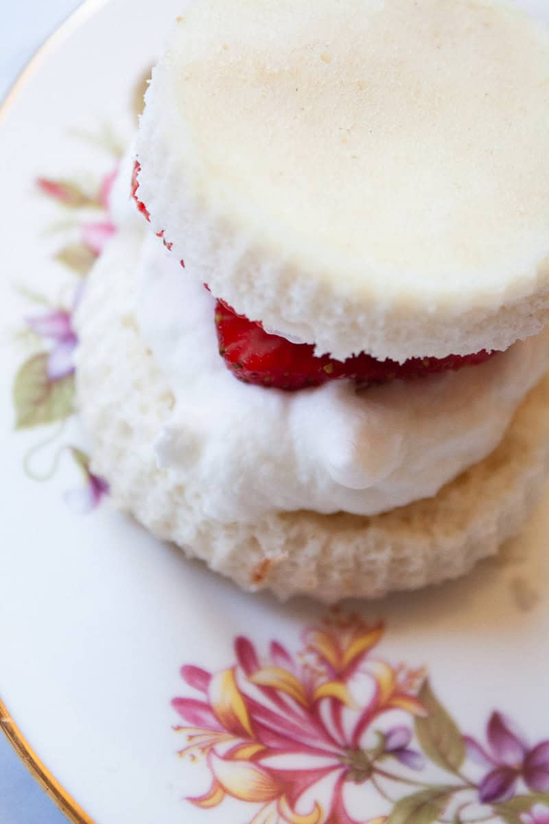 Gluten free strawberry shortcakes with angel food cake, whipped cream, and strawberry slices.