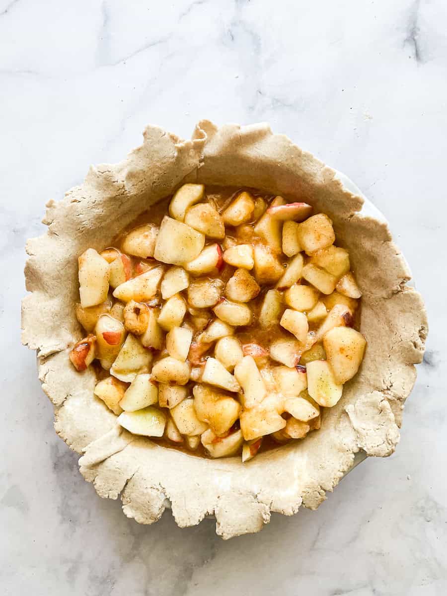 An oat flour pie crust is filled with fruit.