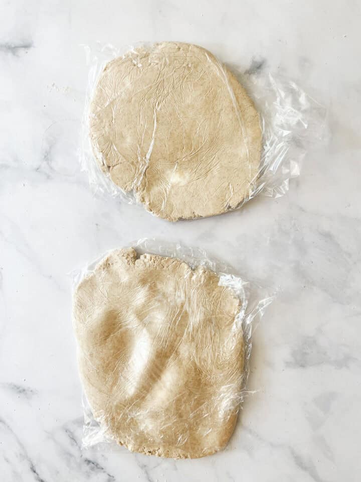 The pie crust is flattened into discs.