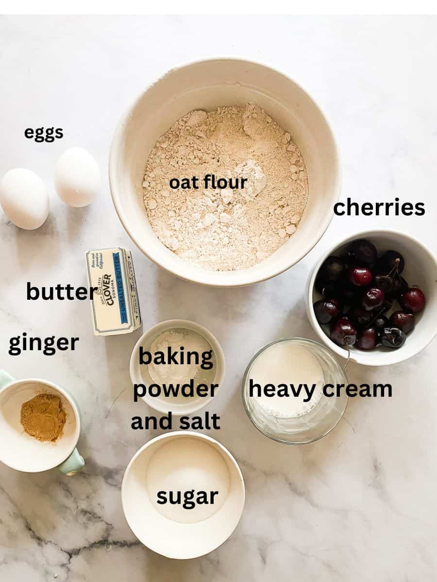 Ingredients for cherry scones: Oat flour, baking powder, salt, cream, butter, eggs, ginger, cherries, sugar.