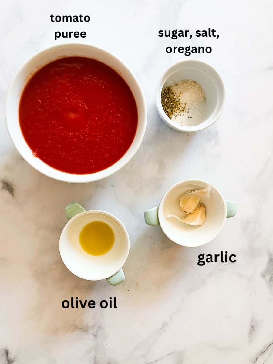 Ingredients for simple tomato sauce are portioned and labeled: pureed tomatoes, garlic, oregano, salt, sugar, olive oil.