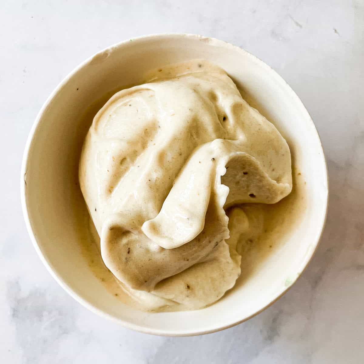 Banana ice cream is served in a bowl.