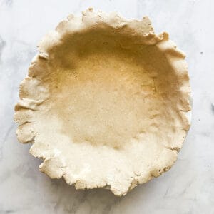 A gluten free pie crust in a pie pan.