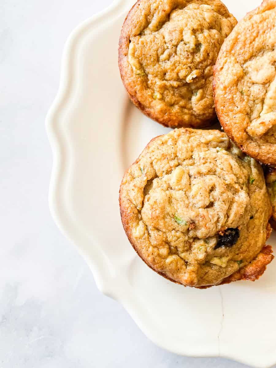 Shreds of zucchini are seen in a gluten free banana zucchini muffin.