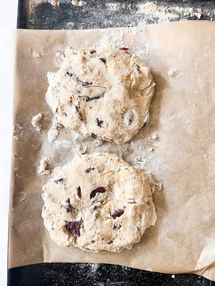 Two discs of scone dough on a baking sheet.