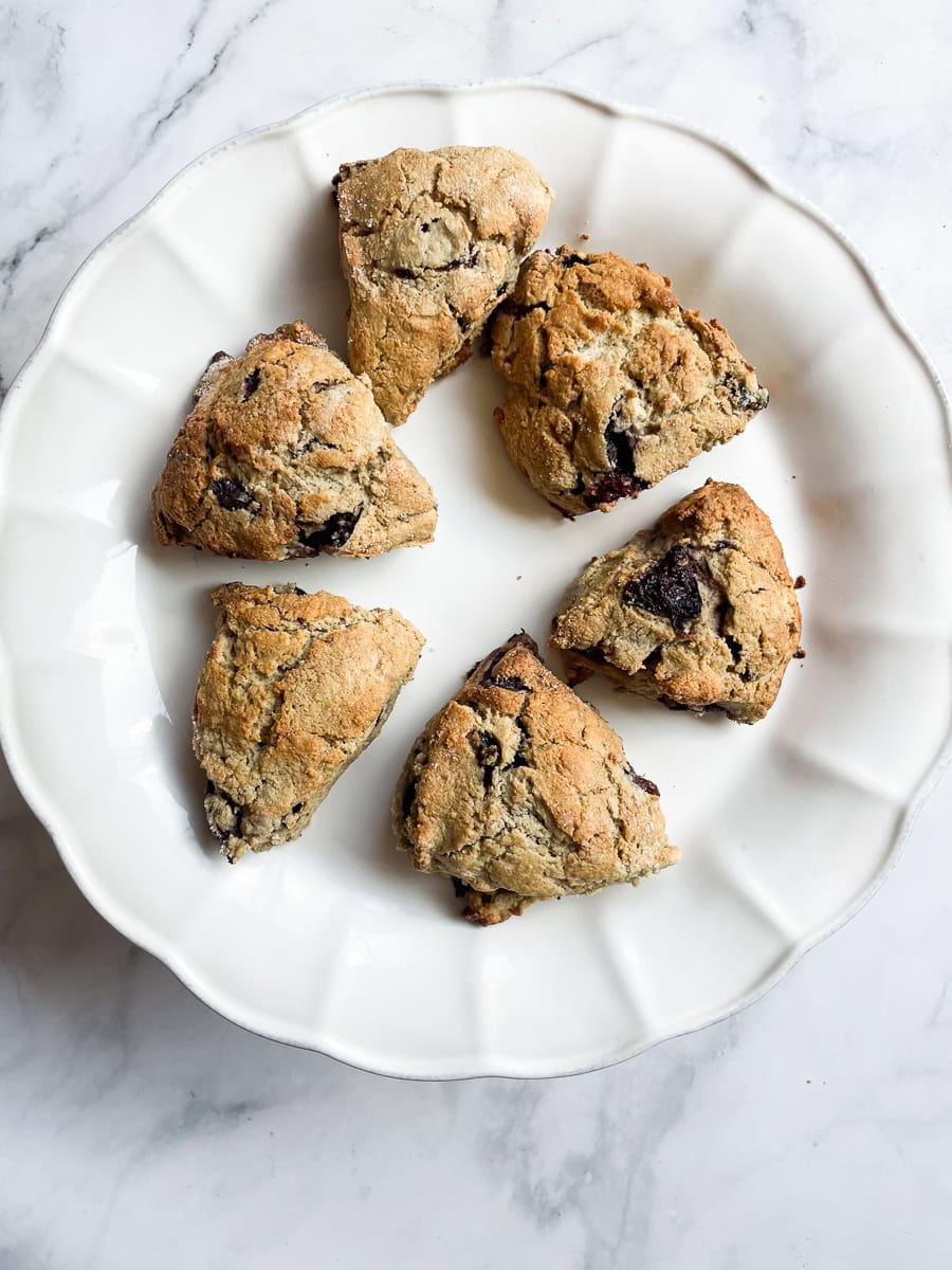 Six gluten free cherry scones on a platter.