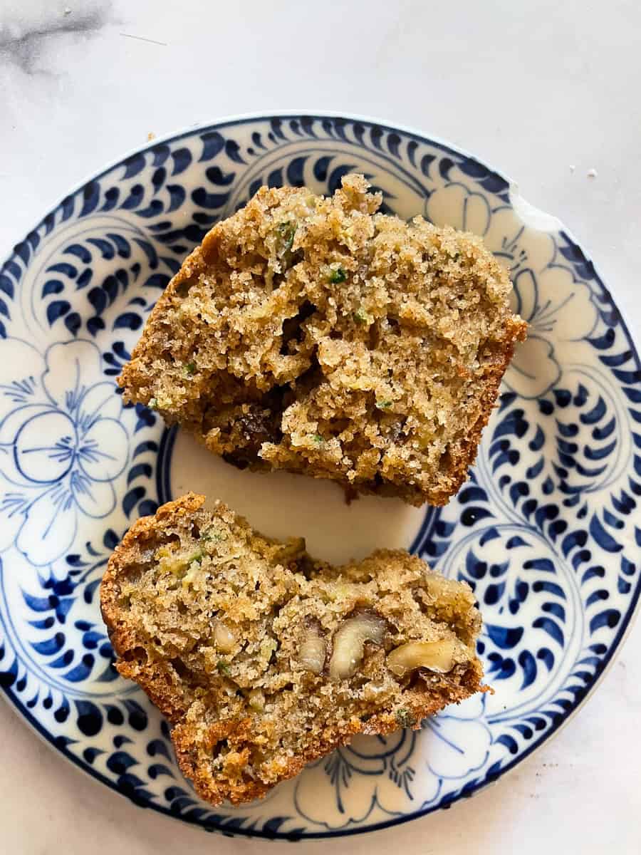 Two halves of a piece of gluten-free zucchini bread on a plate.