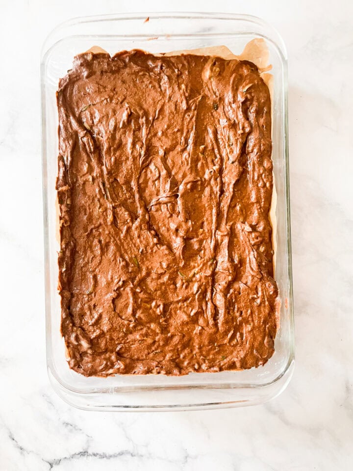 Zucchini chocolate cake is added to the pan.