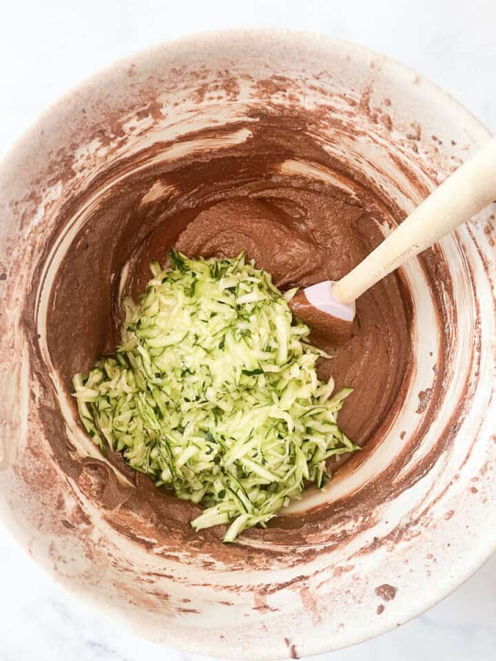 Shredded zucchini is added to the batter.