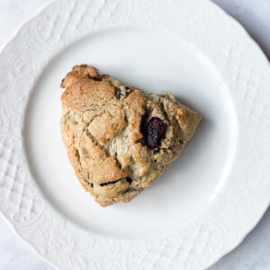 An oat flour scone on a plate.