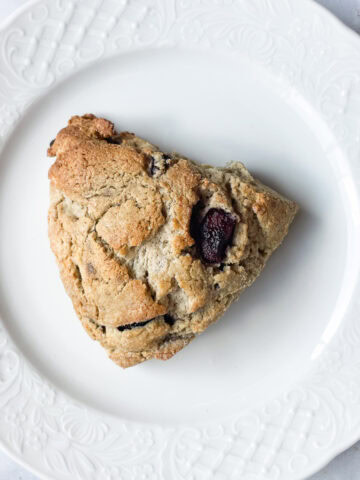 An oat flour scone on a plate.