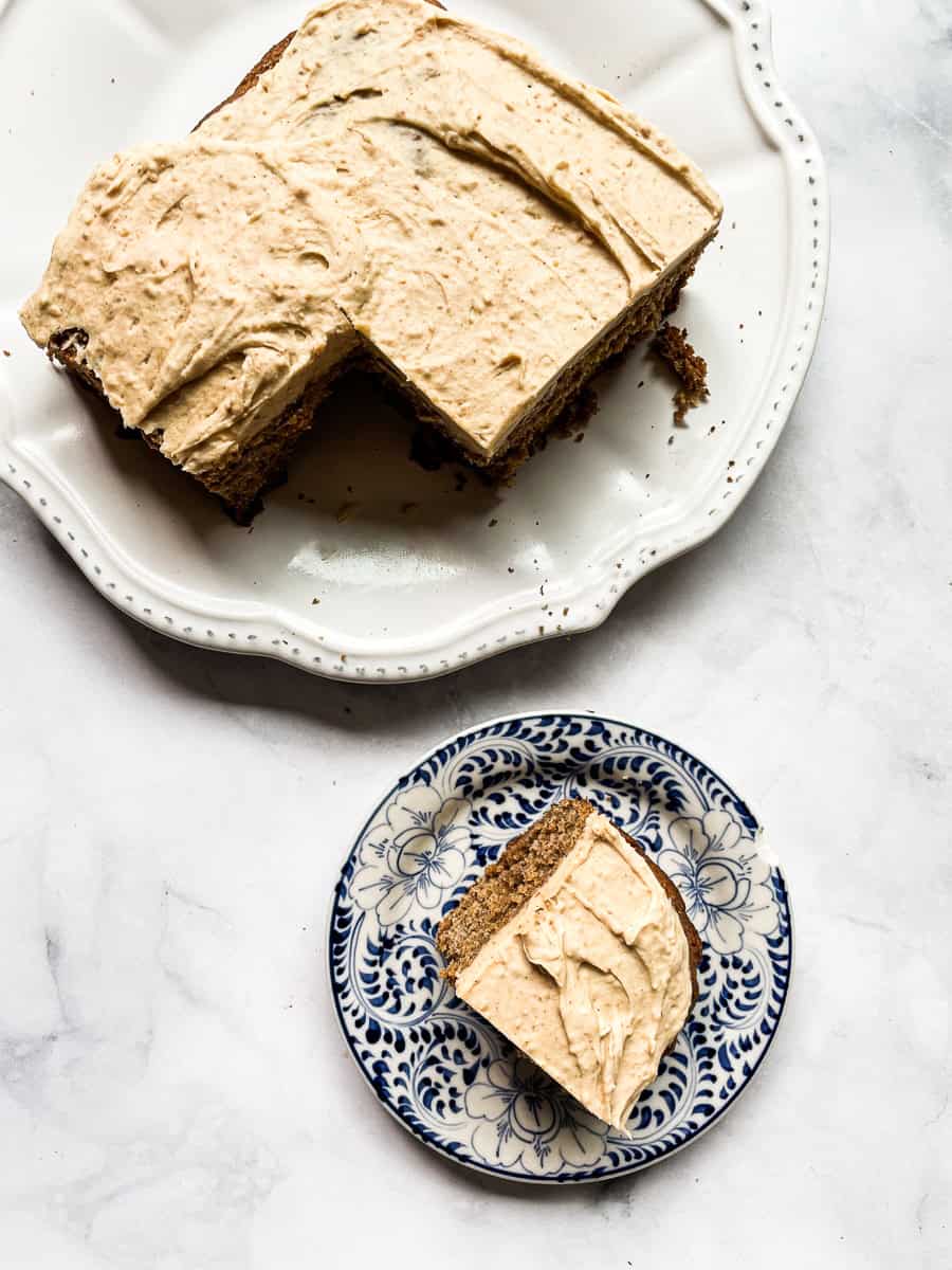 A banana peanut butter cake with a slice cut out.