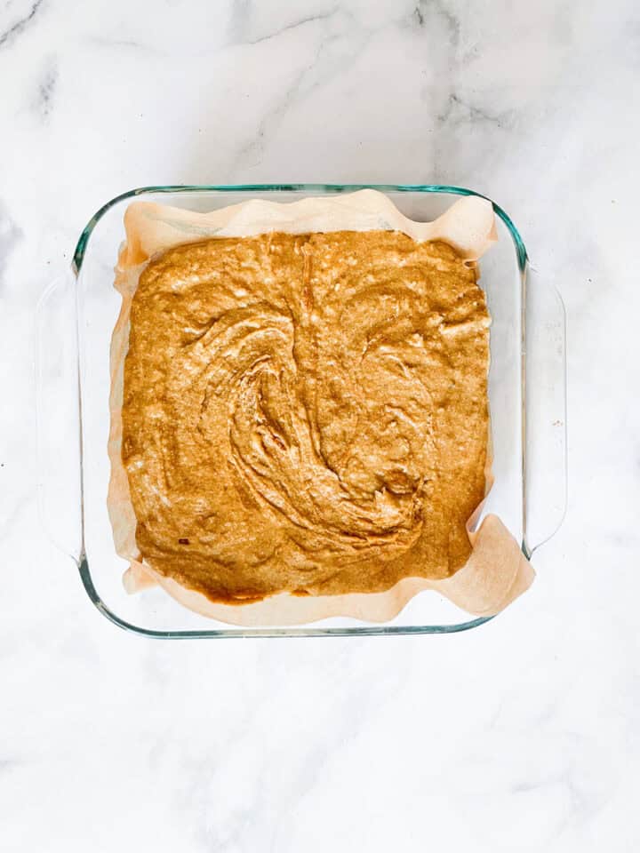 The cake batter is placed in a pan.