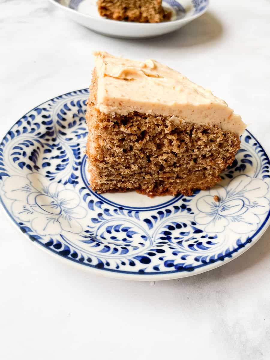 A side view of a piece of banana peanut butter cake on a plate.