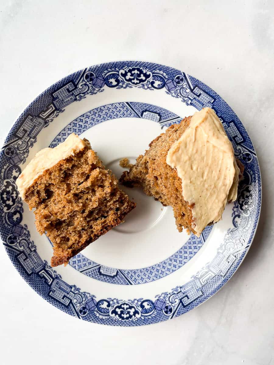 A slice of banana peanut butter cake is cut in half.