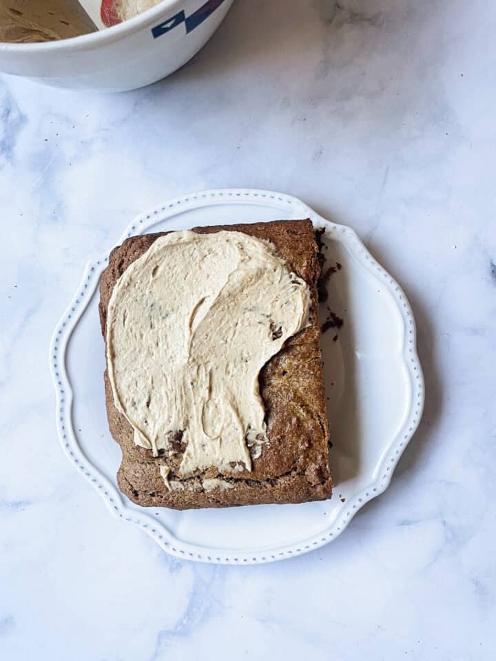 Frosting is added to the cake.