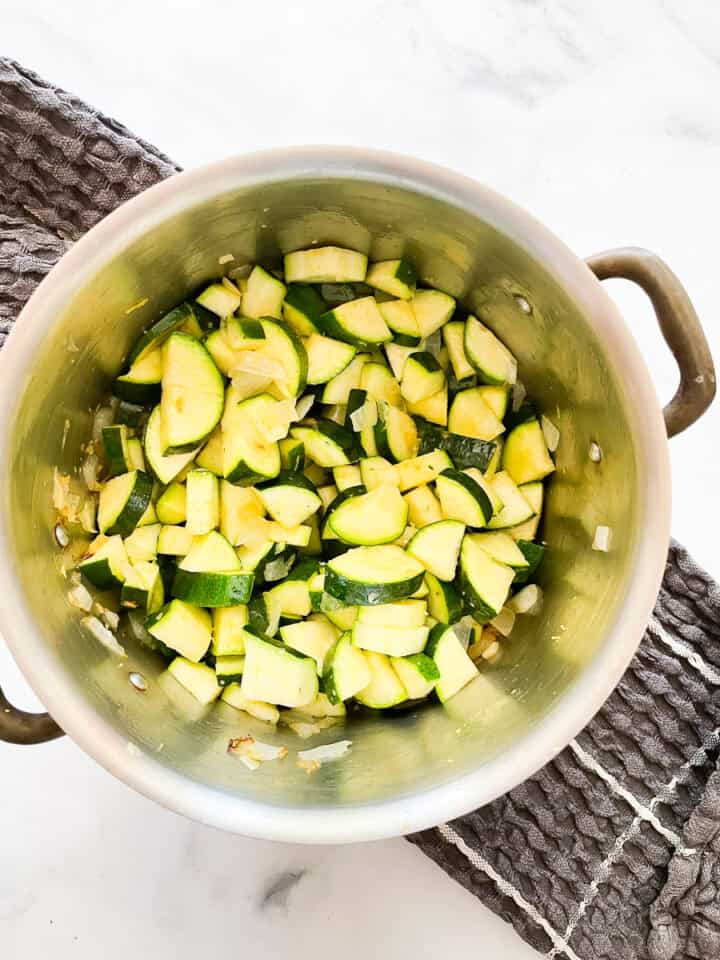 Zucchini is added to the garlic and onion.