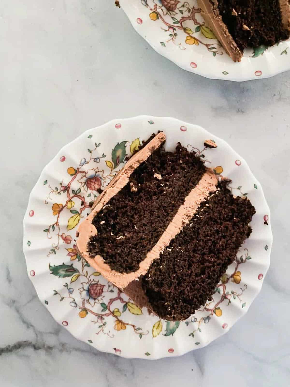 A slice of gluten free chocolate layer cake on a plate.