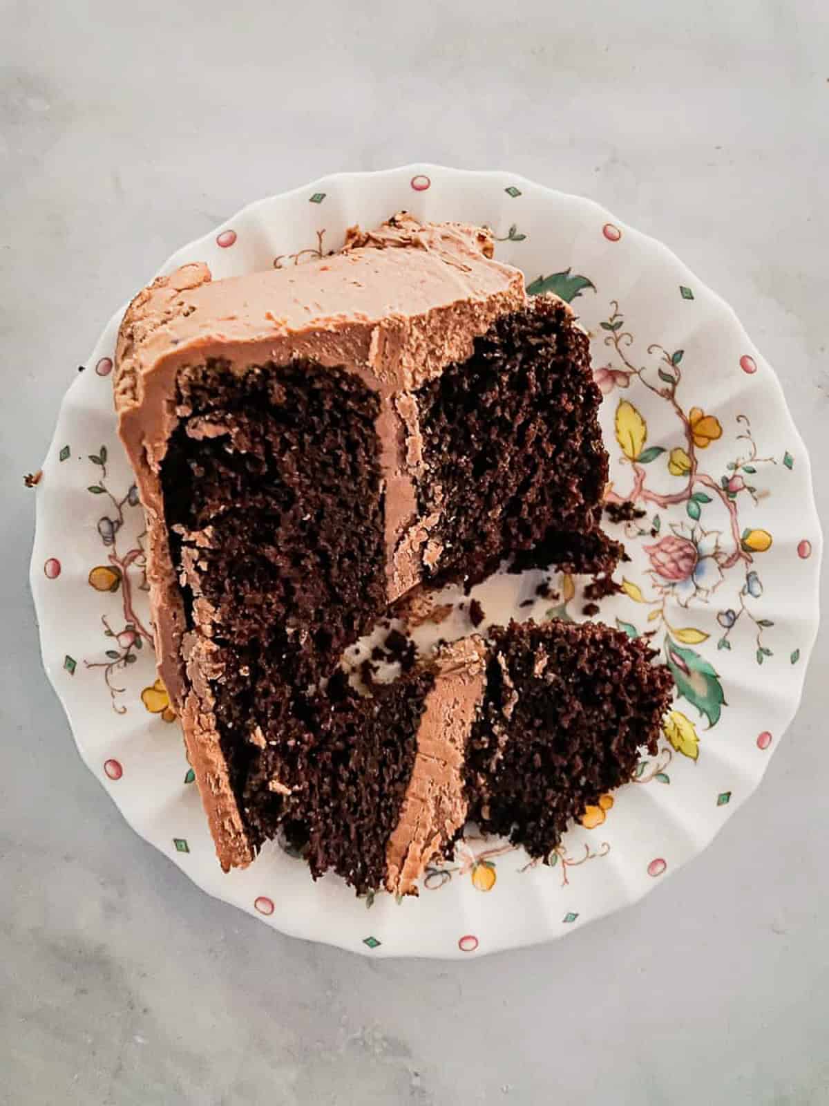 A cut slice of chocolate layer cake on a plate.