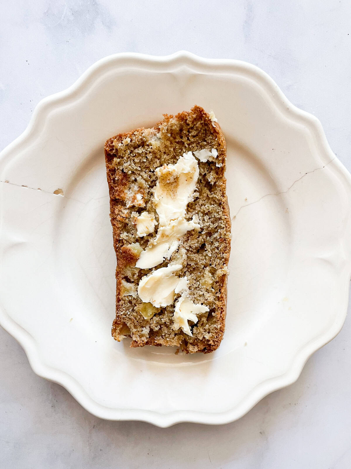 A slice of apple cinnamon bread on a pate.