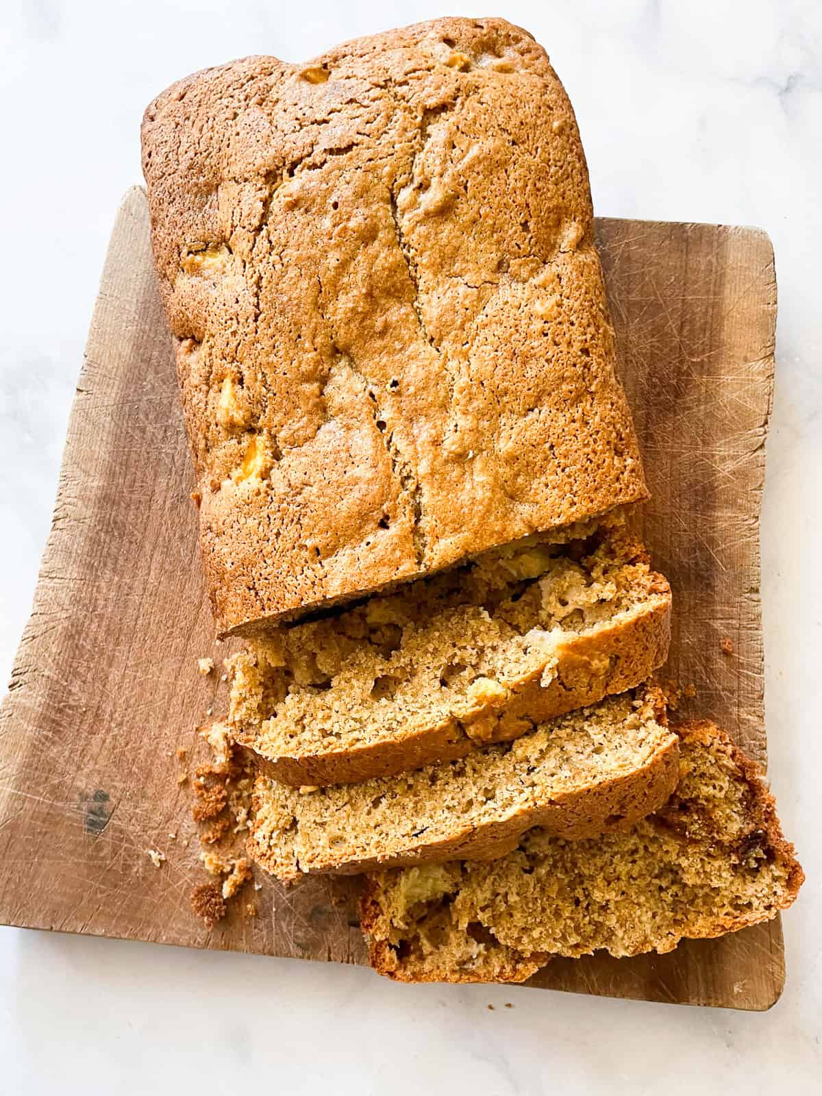 A loaf of gluten free apple cinnamon bread cut into slices.