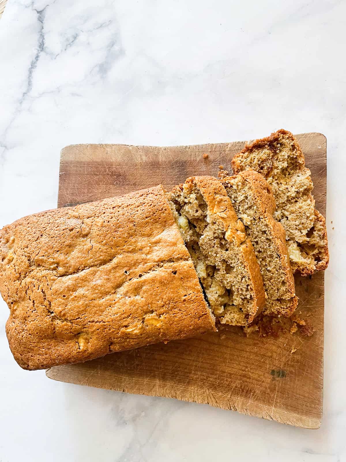 A loaf of gluten free apple cinnamon bread cut into slices.