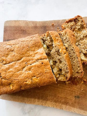 A loaf of gluten free apple cinnamon bread cut into slices.