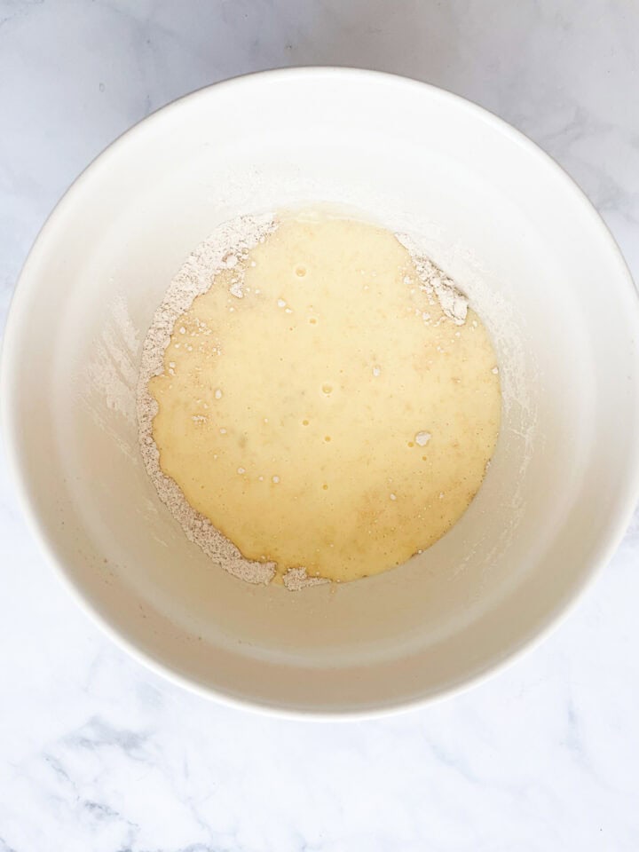 The wet mixture is combined for gluten free banana buttermilk pancakes.