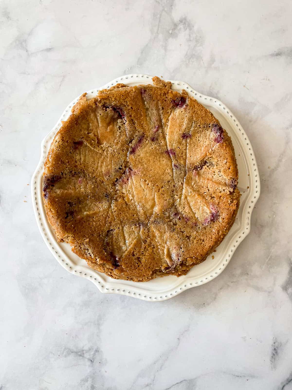 A gluten free plum torte on a plate.