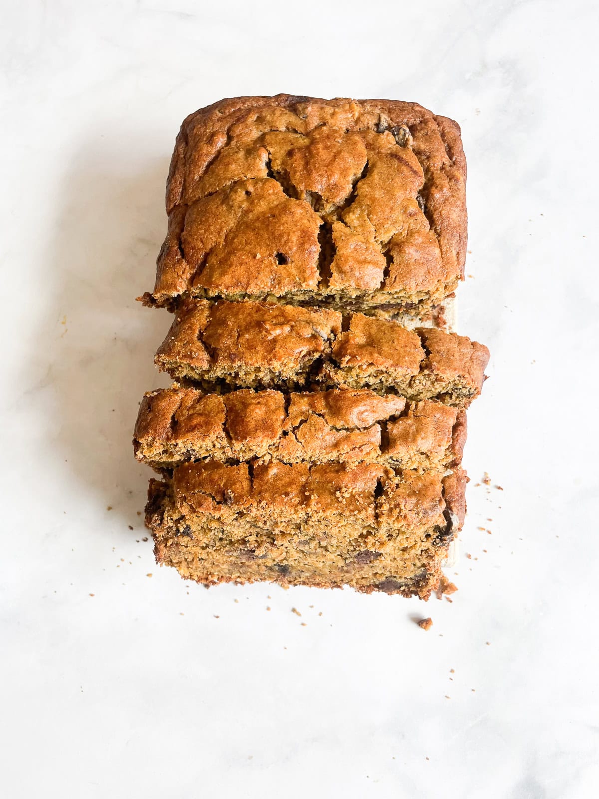 A gluten free pumpkin banana bread loaf cut in slices.