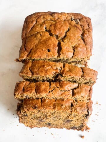 A gluten free pumpkin banana bread loaf cut in slices.