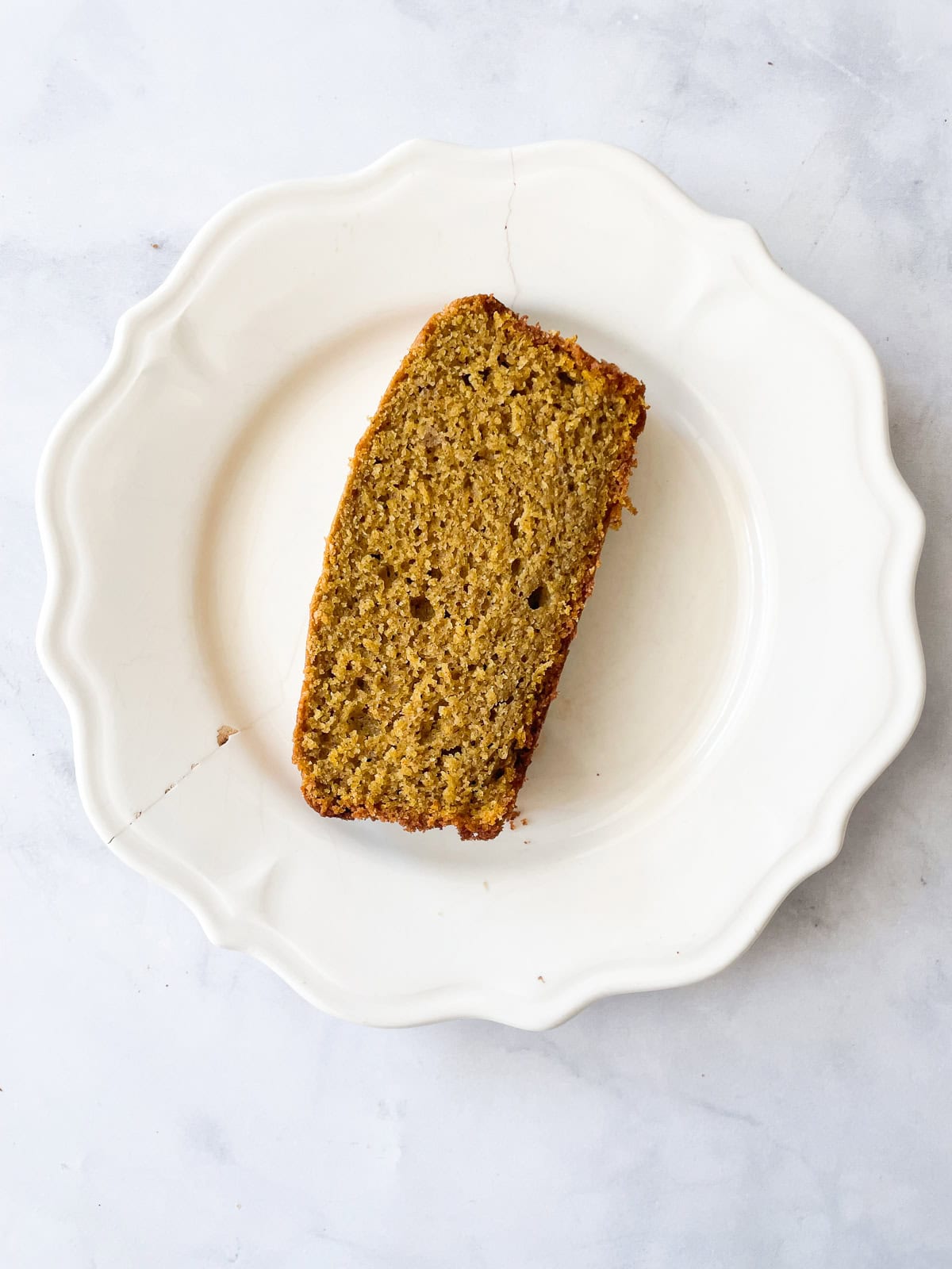 Slice of pumpkin bread on a plate.