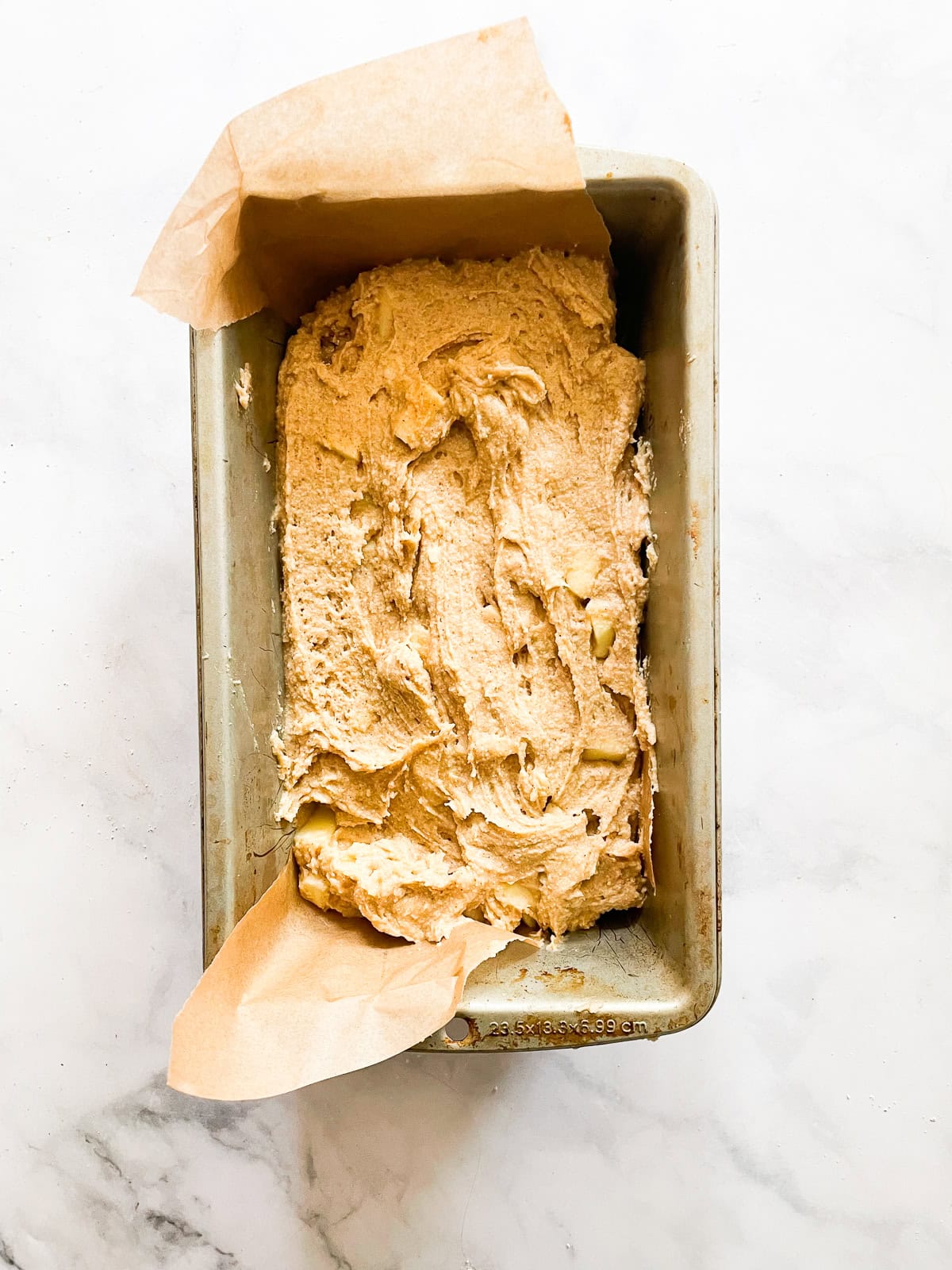 Apple bread batter in a loaf pan.