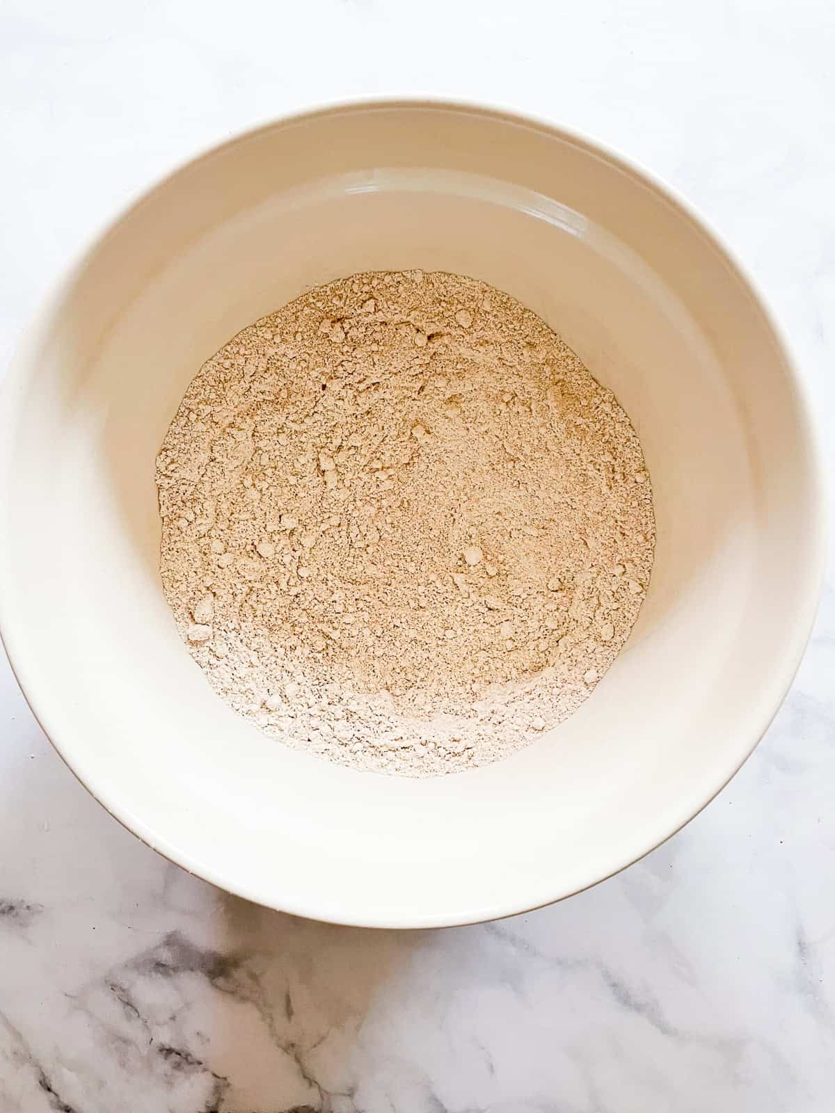 Flour mixed with baking powder in a bowl.