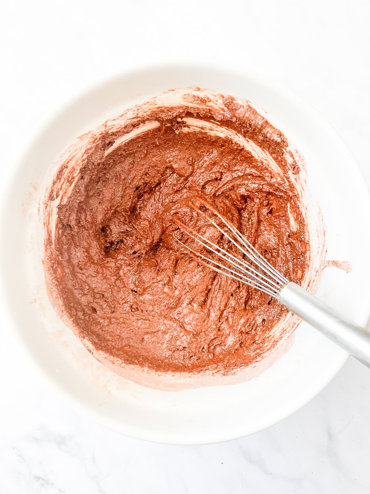 Chocolate layer cake batter in a bowl.