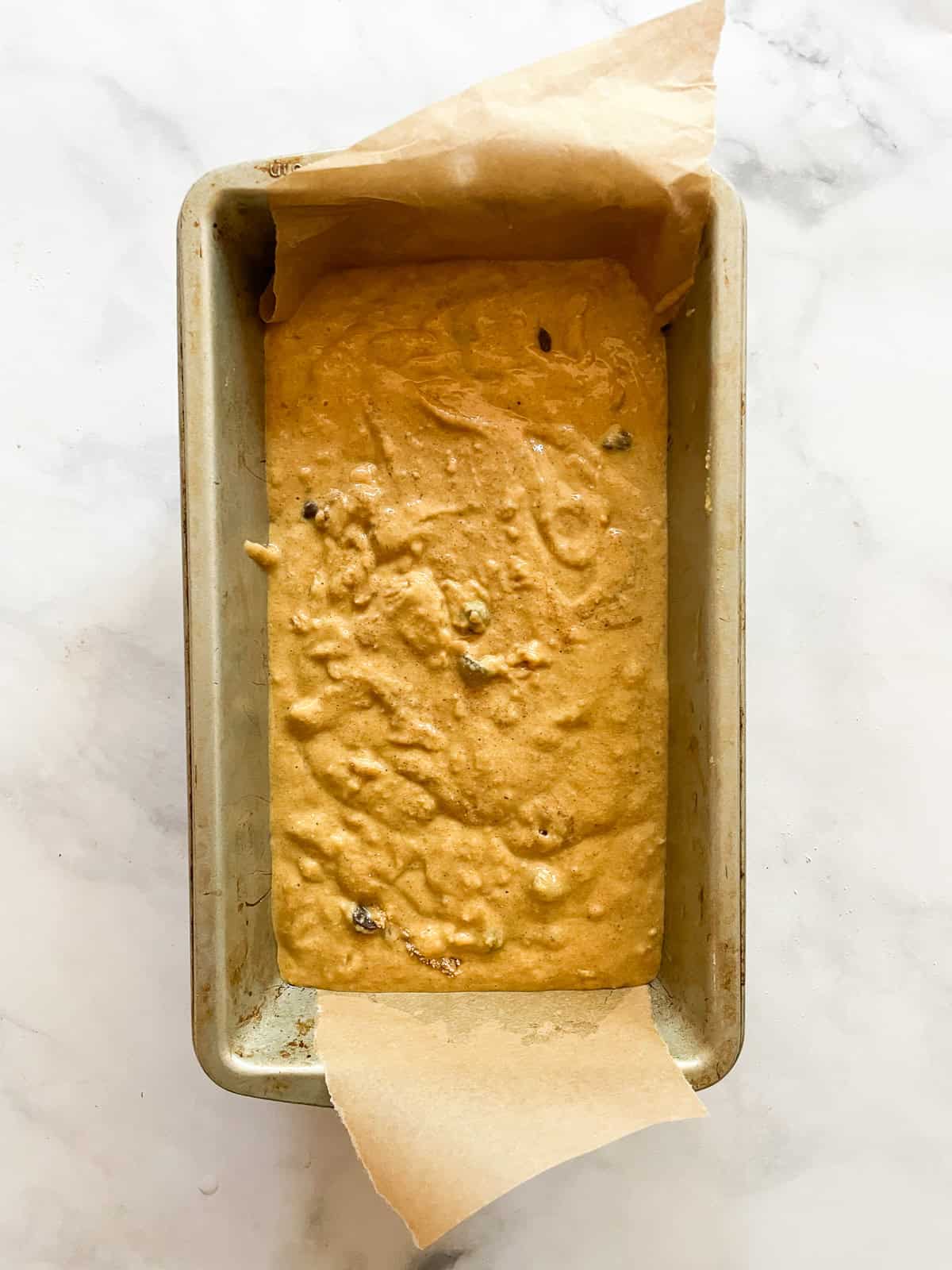 The batter for pumpkin banana bread in a loaf pan.