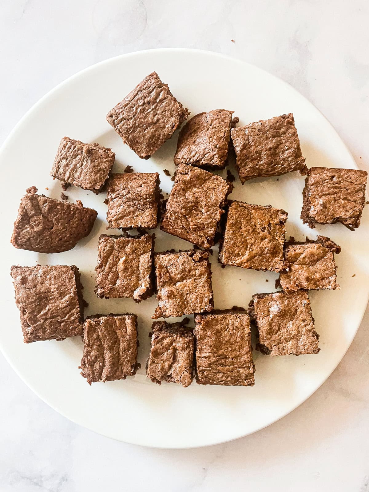 Small squares of whole wheat brownies on a white plate.