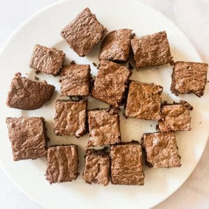 Small squares of whole wheat brownies on a white plate.