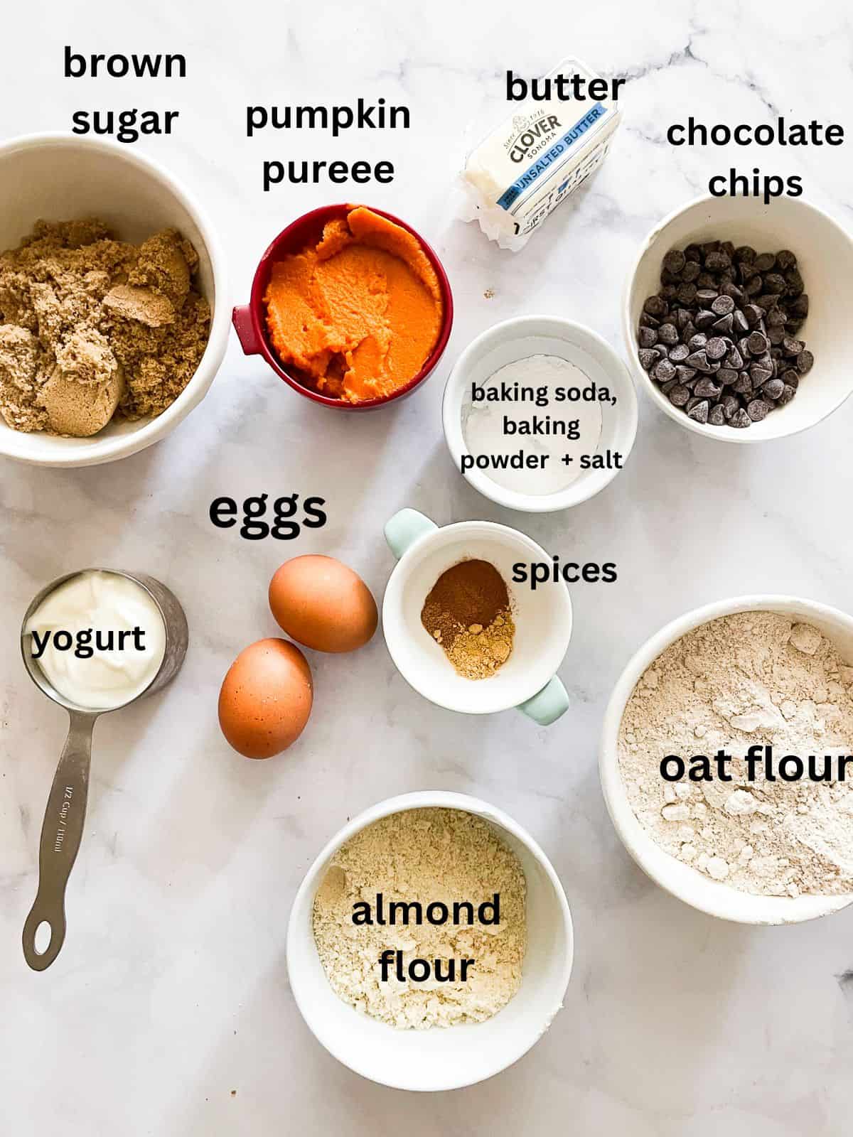 Text-labeled ingredients for gluten free pumpkin chocolate chip muffins including pumpkin puree and chocolate chips.